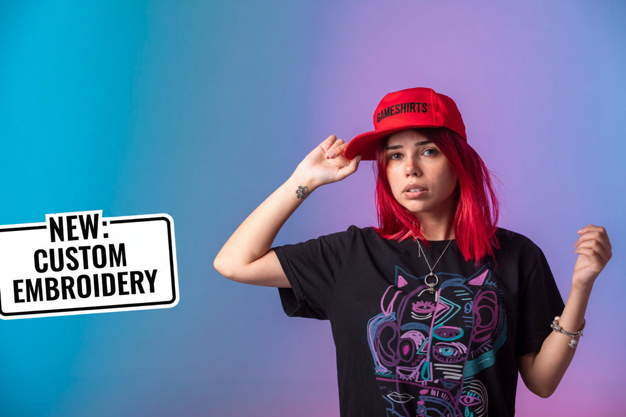 Person wearing a red cap and black t-shirt with colorful design against a gradient background