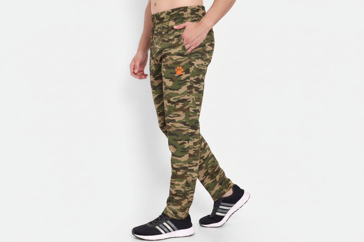Person wearing green athletic pants with a brand logo on a white background