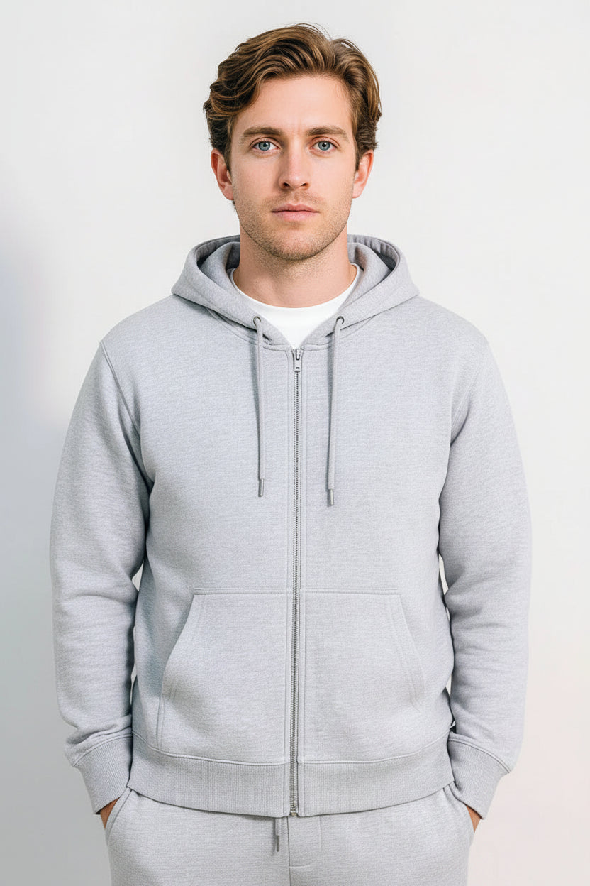 Man wearing a gray hoodie against a plain background