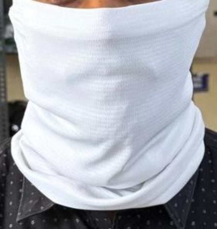 Person wearing a white face mask with a blurred background